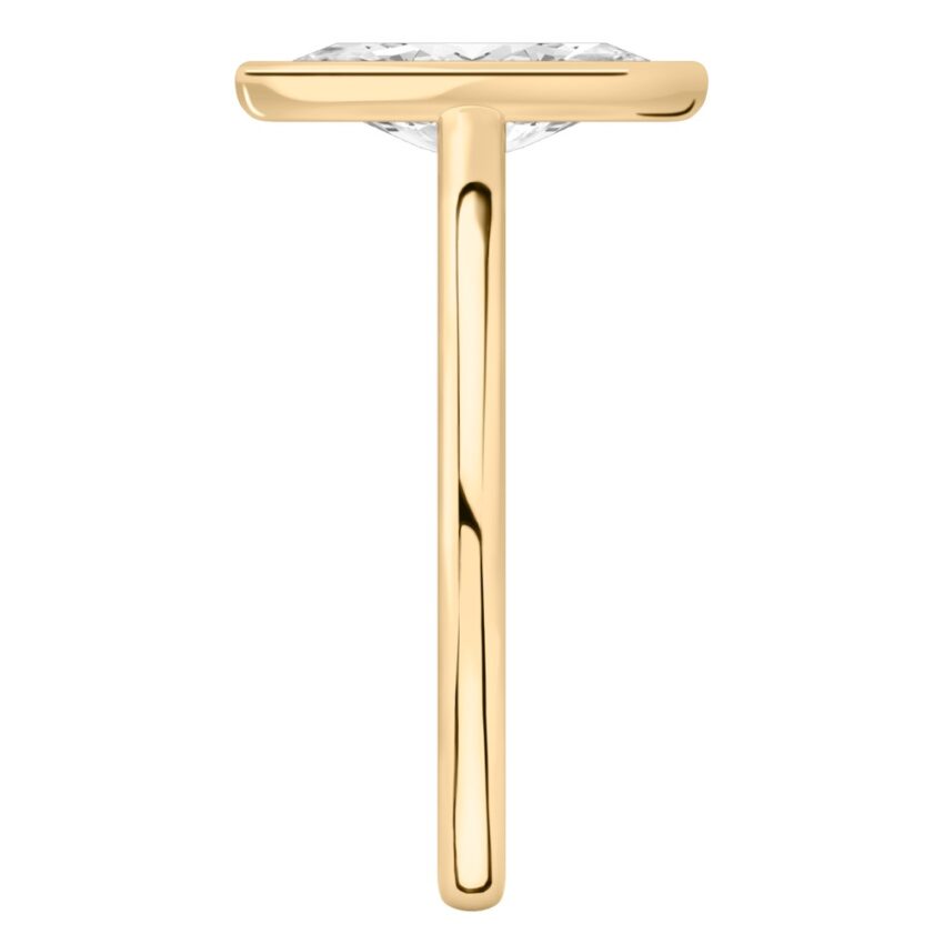 Side view of marquise cut diamond bezel engagement ring in yellow gold
