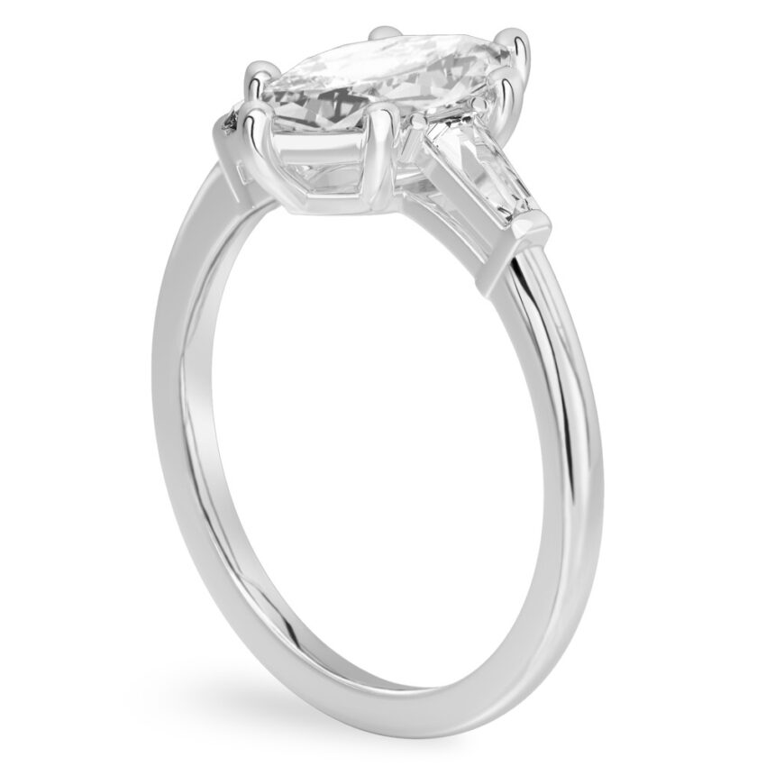Angle view of marquise cut diamond tapered baguette engagement ring in palladium