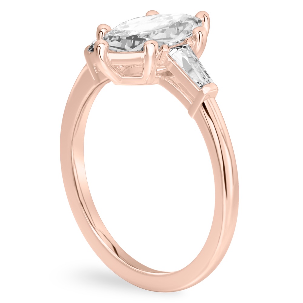 Angle view of marquise cut diamond tapered baguette engagement ring in rose gold