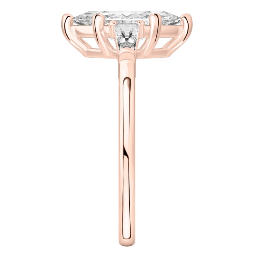 Side view of marquise cut diamond tapered baguette engagement ring in rose gold