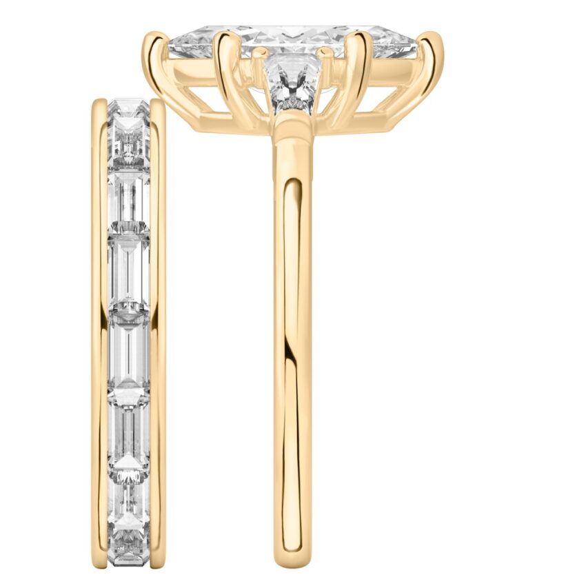 Side view of marquise cut diamond tapered baguette engagement ring set yellow gold