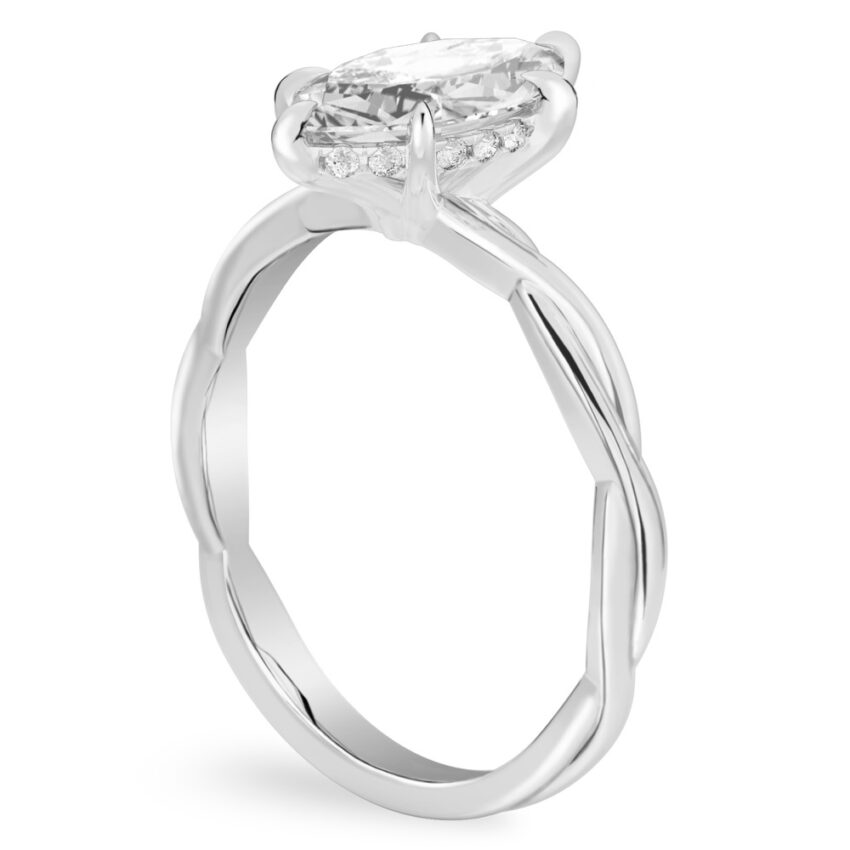 Angle view of marquise cut diamond twisted hidden halo engagement ring in platinum