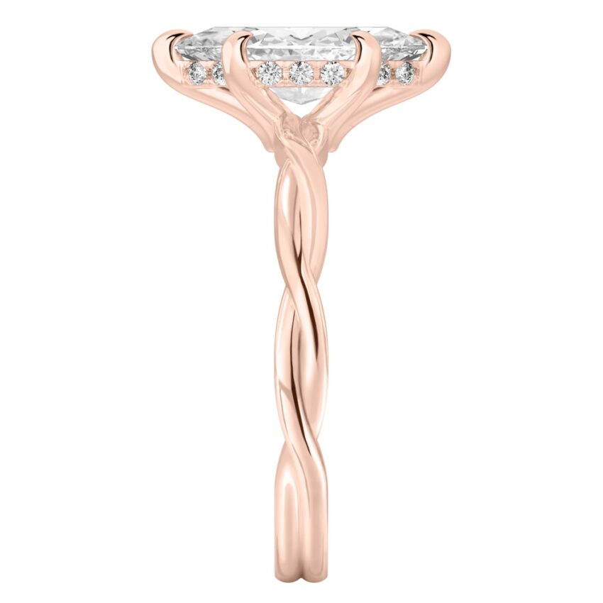 Side view of marquise cut diamond twisted hidden halo engagement ring in rose gold