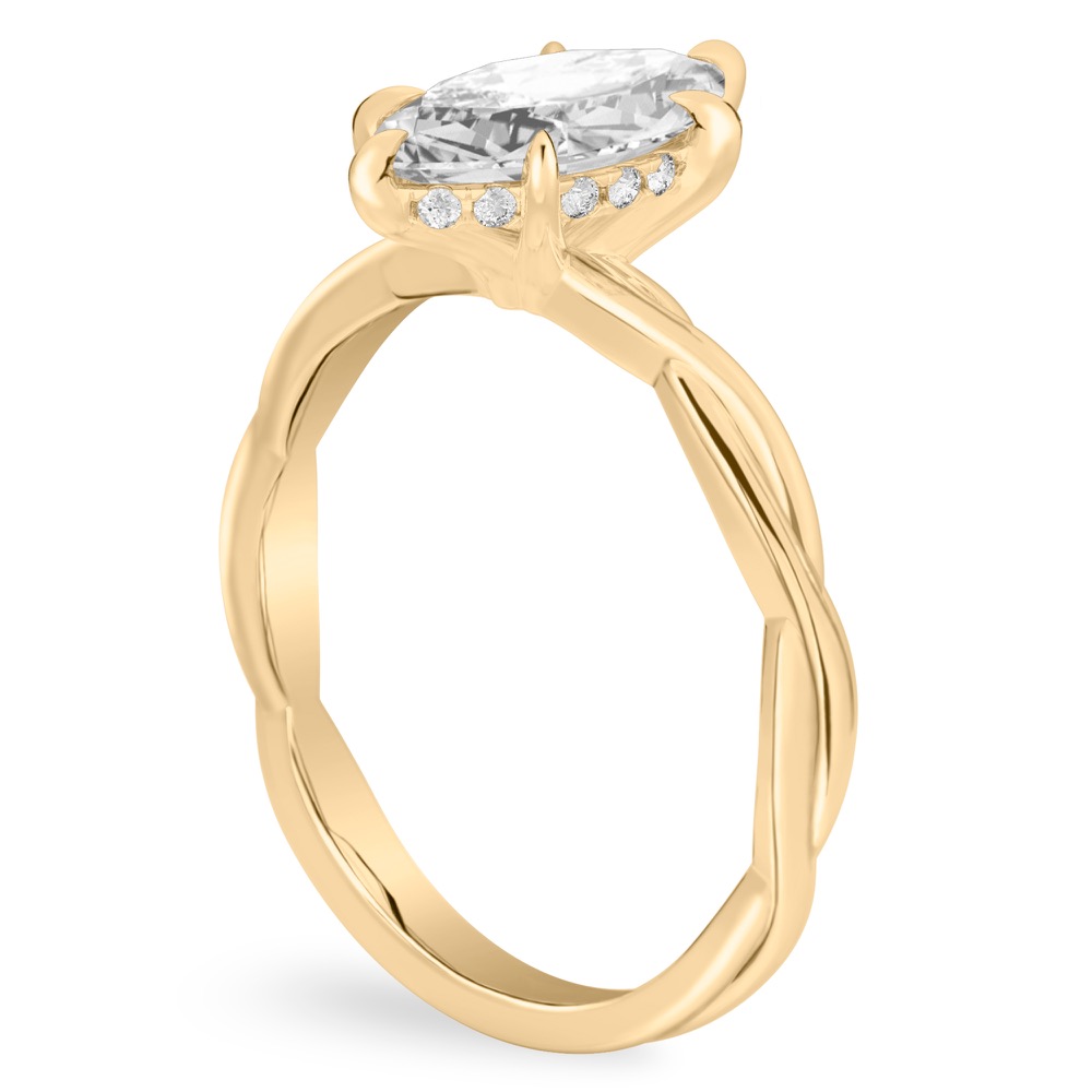Angle view of marquise cut diamond twisted hidden halo engagement ring in yellow gold