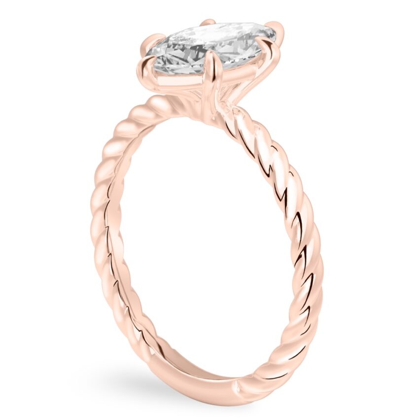 Angle view of marquise cut diamond twisted rope engagement ring in rose gold