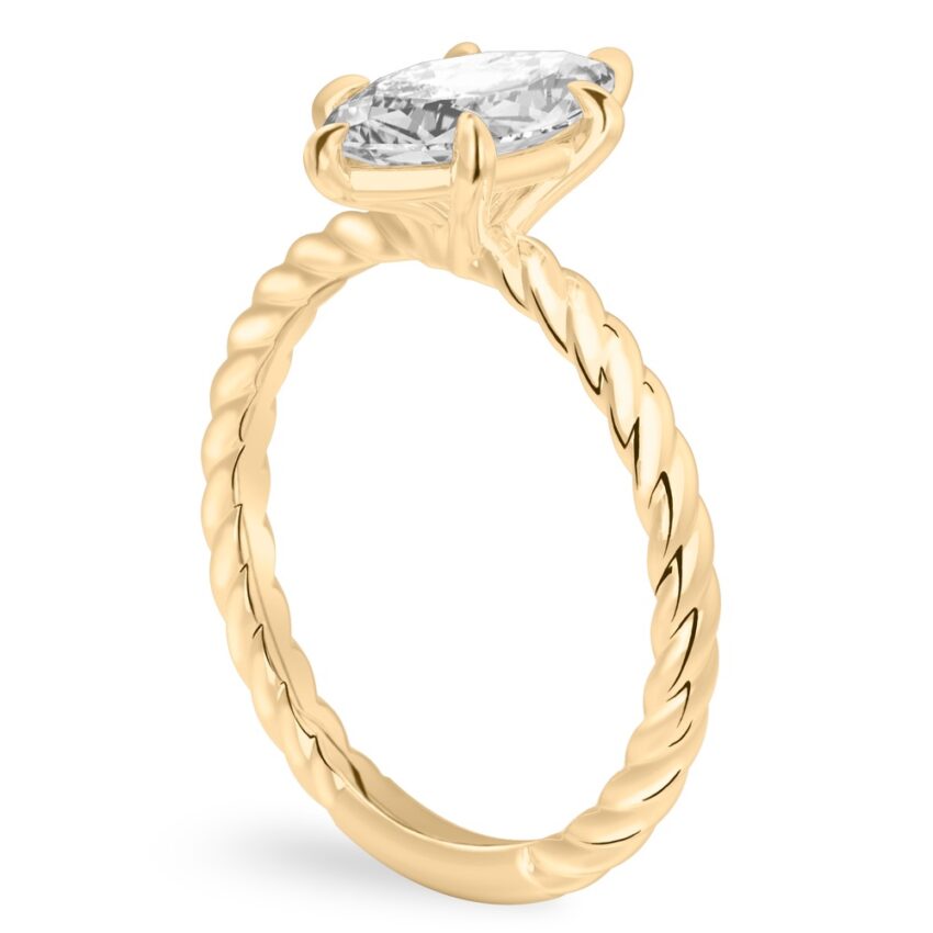 Angle view of marquise cut diamond twisted rope engagement ring in yellow gold