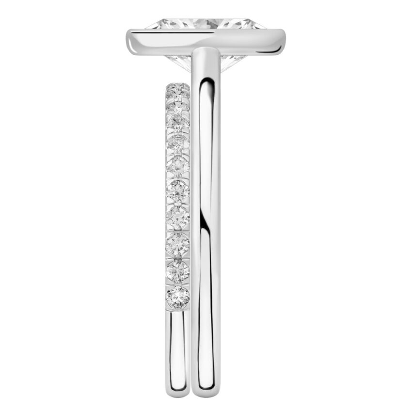 Side view of oval shape diamond bezel engagement ring set platinum