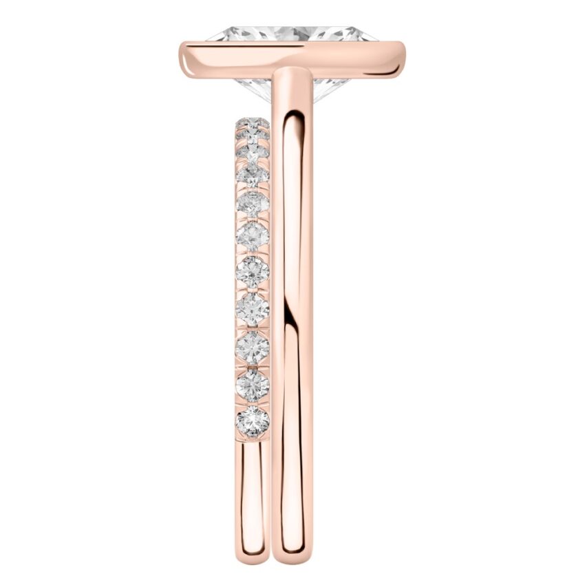 Side view of oval shape diamond bezel engagement ring set rose gold