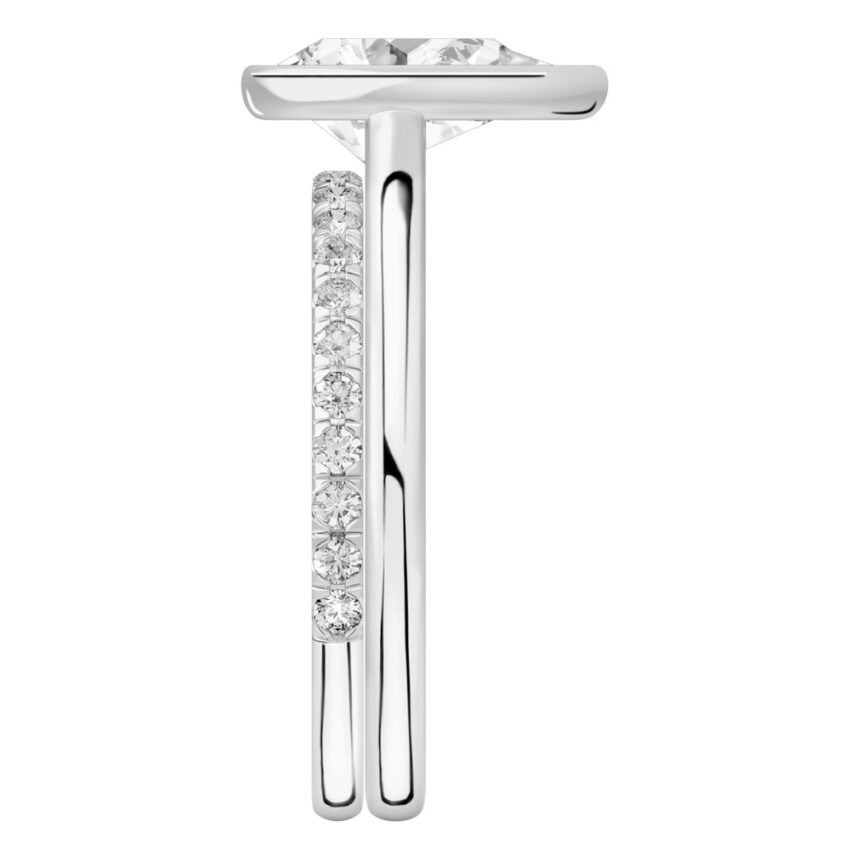 Side view of pear shape diamond bezel engagement ring set platinum
