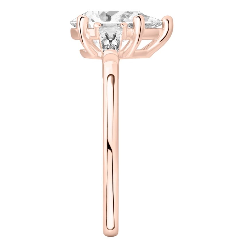 Side view of pear shape diamond tapered baguette engagement ring in rose gold