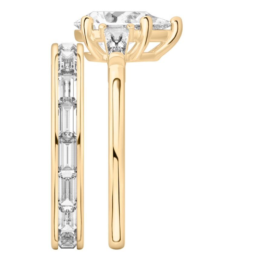 Side view of pear shape diamond tapered baguette engagement ring set yellow gold