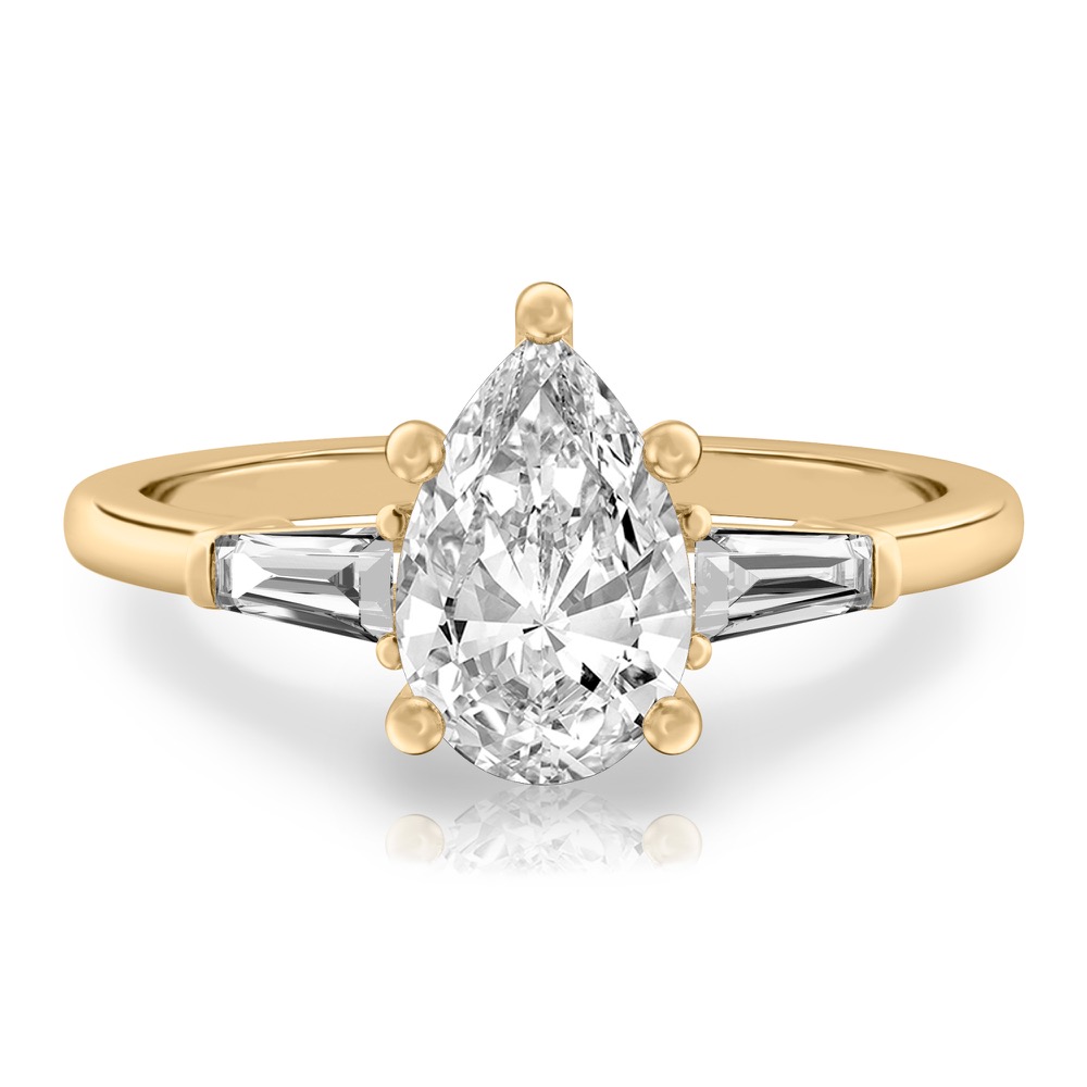 pear shape diamond tapered baguette engagement ring in yellow gold