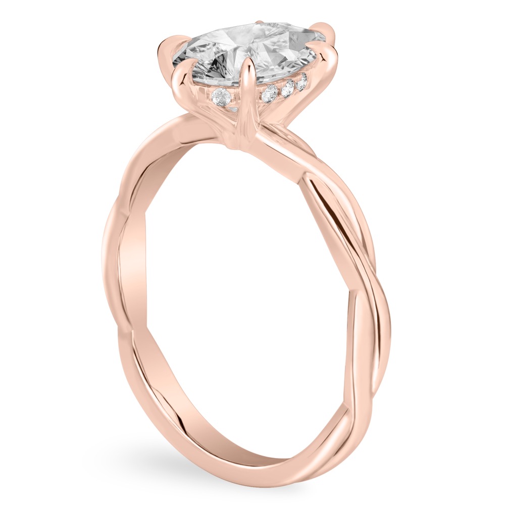 Angle view of pear shape diamond twisted hidden halo engagement ring in rose gold