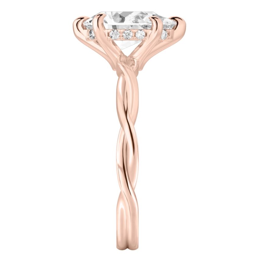 Side view of pear shape diamond twisted hidden halo engagement ring in rose gold