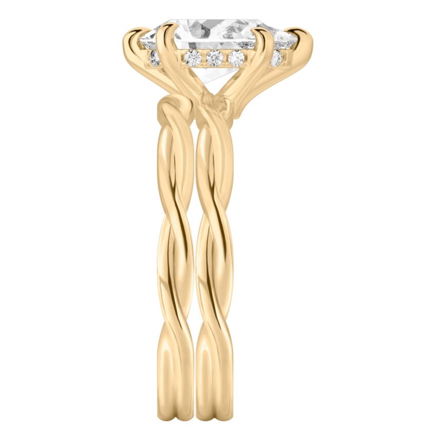 Side view of pear shape diamond twisted hidden halo engagement ring set yellow gold