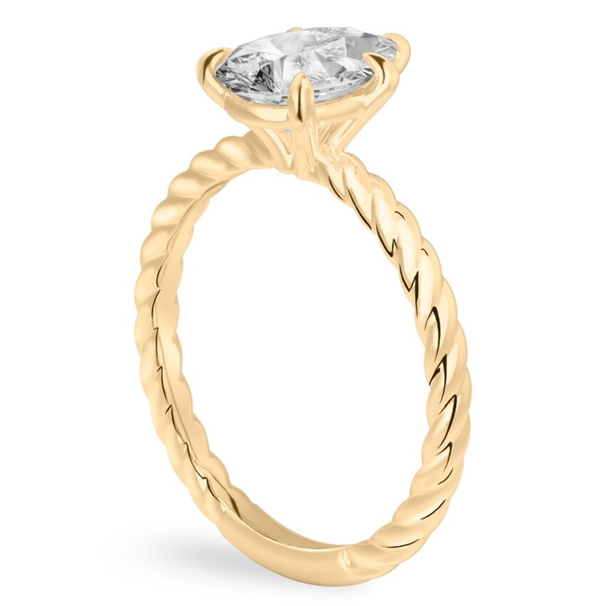 Angle view of pear shape diamond twisted rope engagement ring in yellow gold
