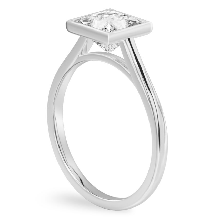 Angle view of princess cut diamond bezel engagement ring in platinum