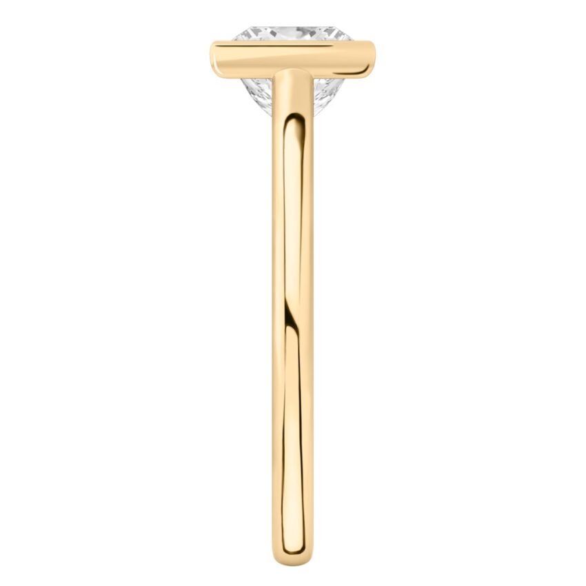 Side view of princess cut diamond bezel engagement ring in yellow gold