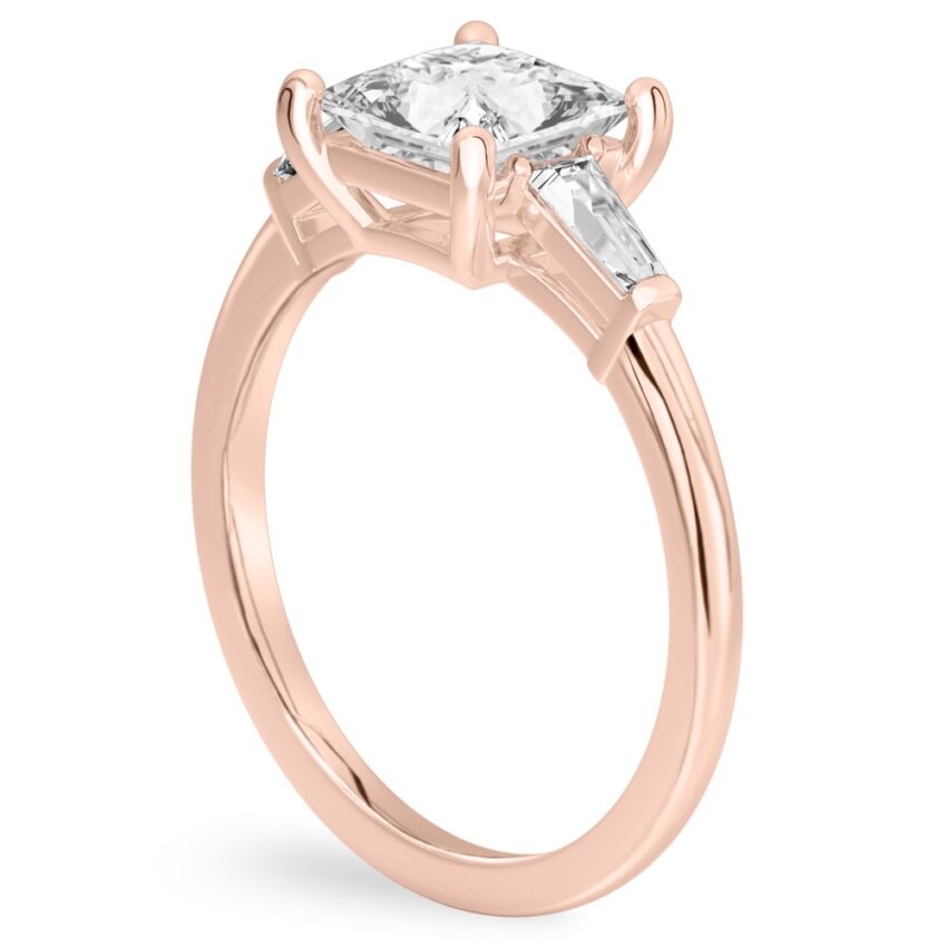 Angle view of princess cut diamond tapered baguette engagement ring in rose gold