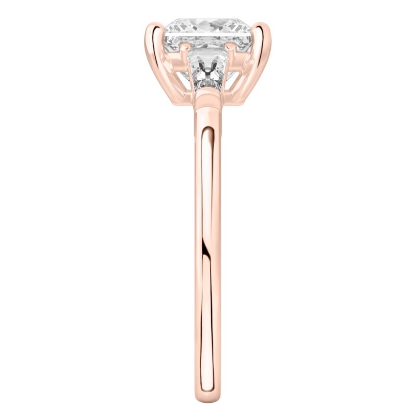 Side view of princess cut diamond tapered baguette engagement ring in rose gold
