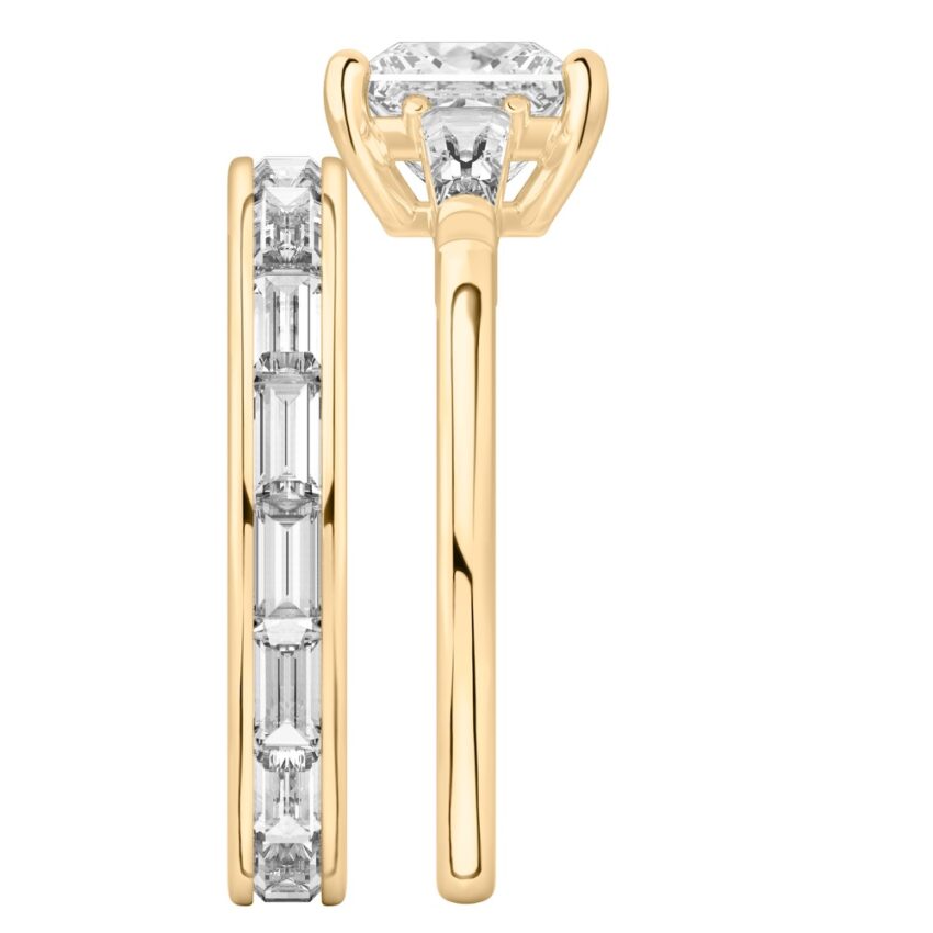 Side view of princess cut diamond tapered baguette engagement ring set yellow gold