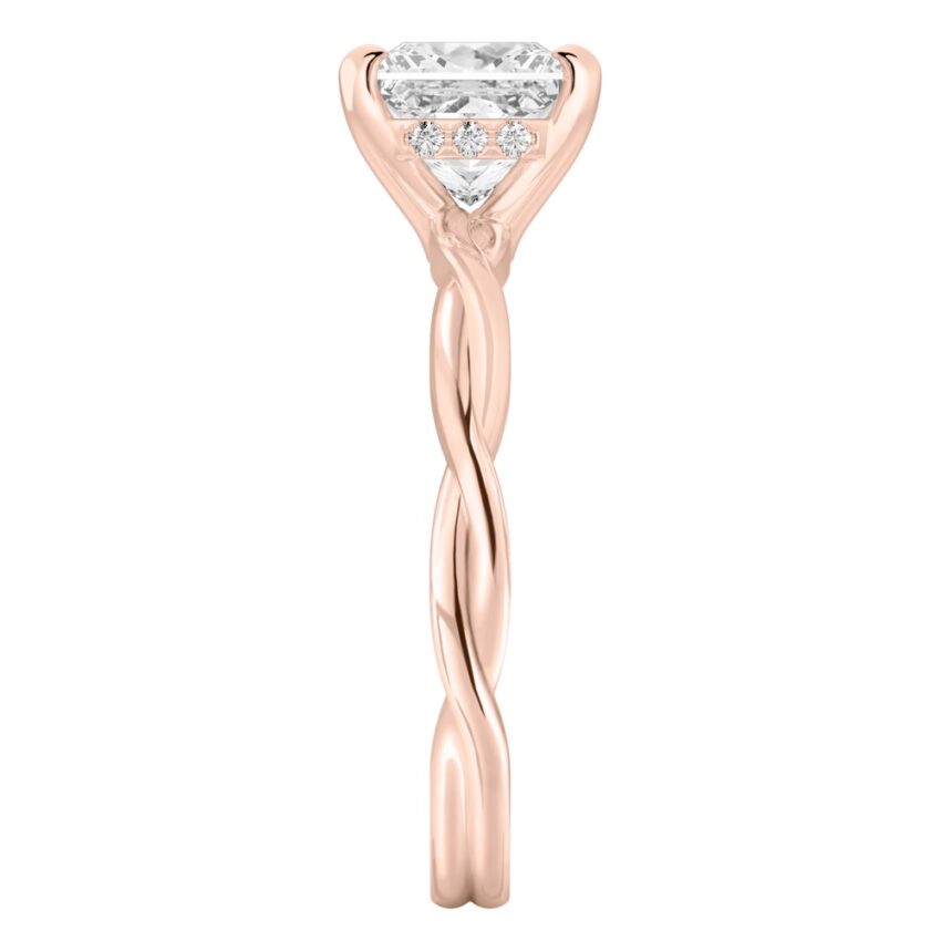 Side view of princess cut diamond twisted hidden halo engagement ring in rose gold