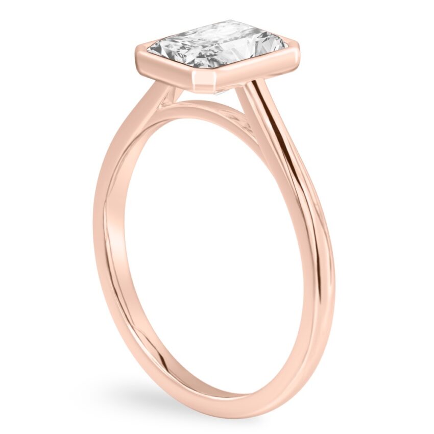 Angle view of radiant cut diamond bezel engagement ring in rose gold