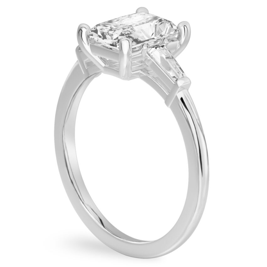 Angle view of radiant cut diamond tapered baguette engagement ring in palladium