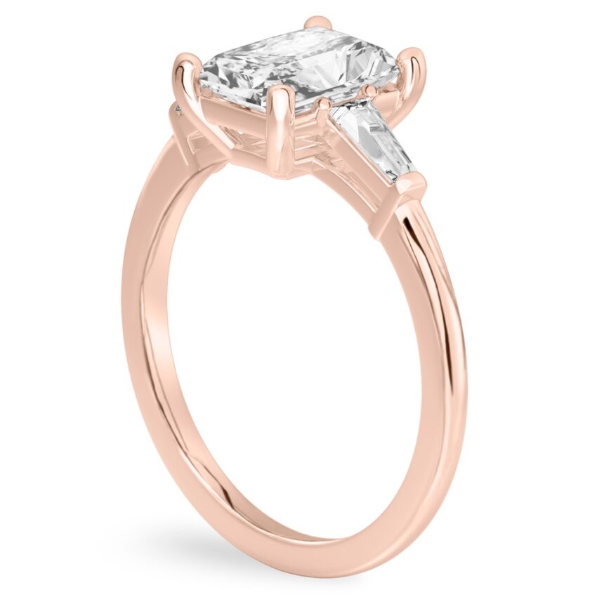 Angle view of radiant cut diamond tapered baguette engagement ring in rose gold