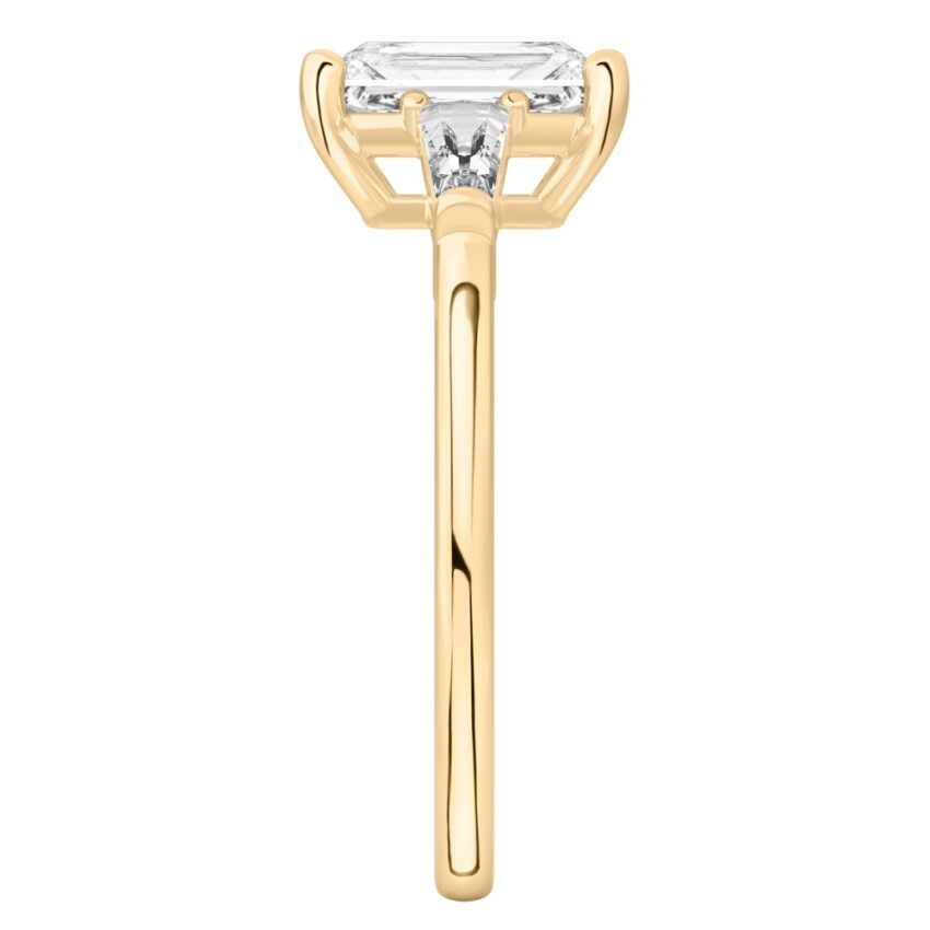 Side view of radiant cut diamond tapered baguette engagement ring in yellow gold