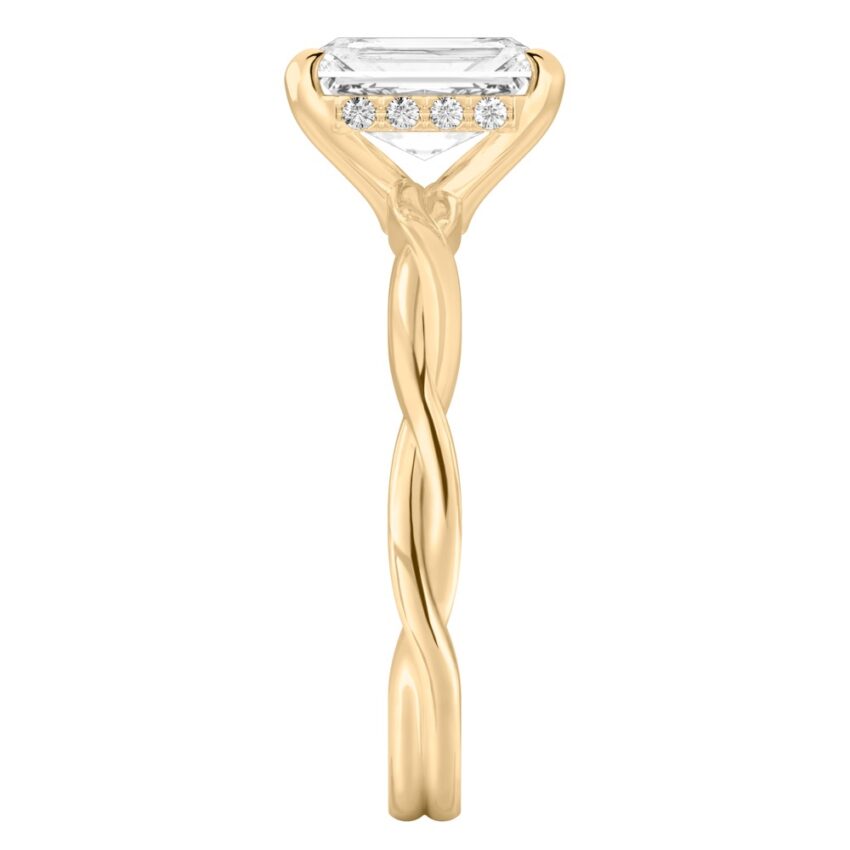 Side view of radiant cut diamond twisted hidden halo engagement ring in yellow gold