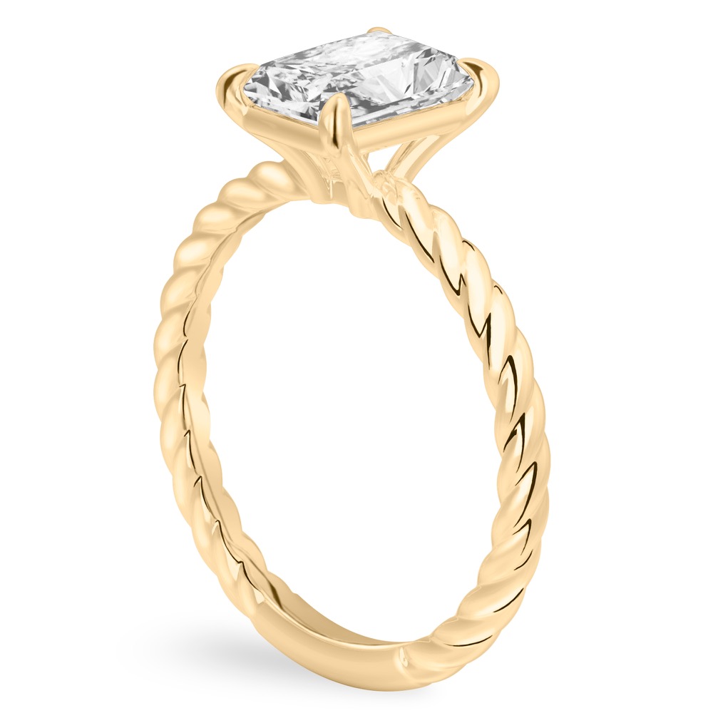 Angle view of radiant cut diamond twisted rope engagement ring in yellow gold