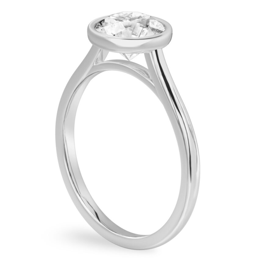 Angle view of round cut diamond bezel engagement ring in platinum
