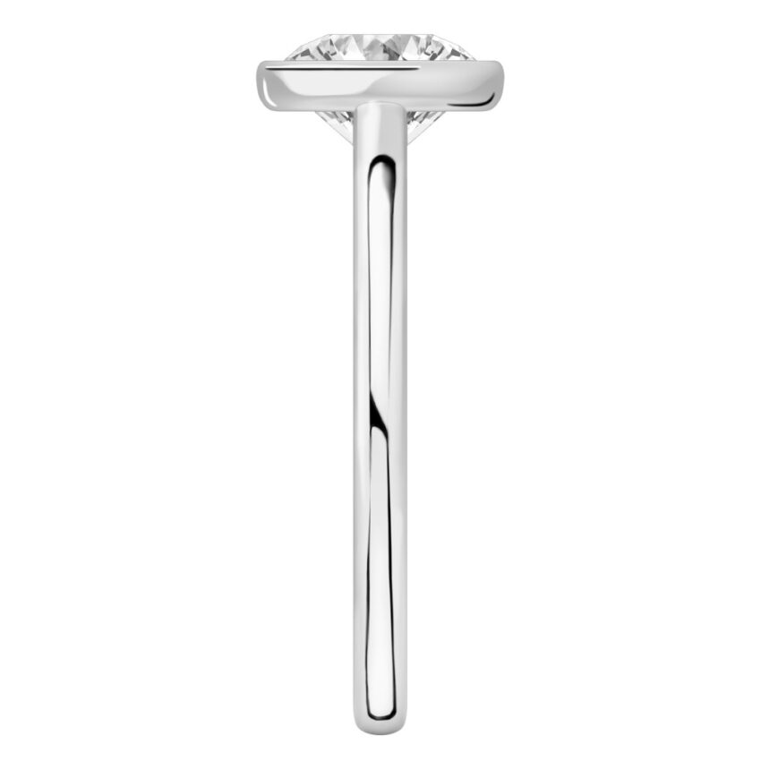 Side view of round cut diamond bezel engagement ring in platinum