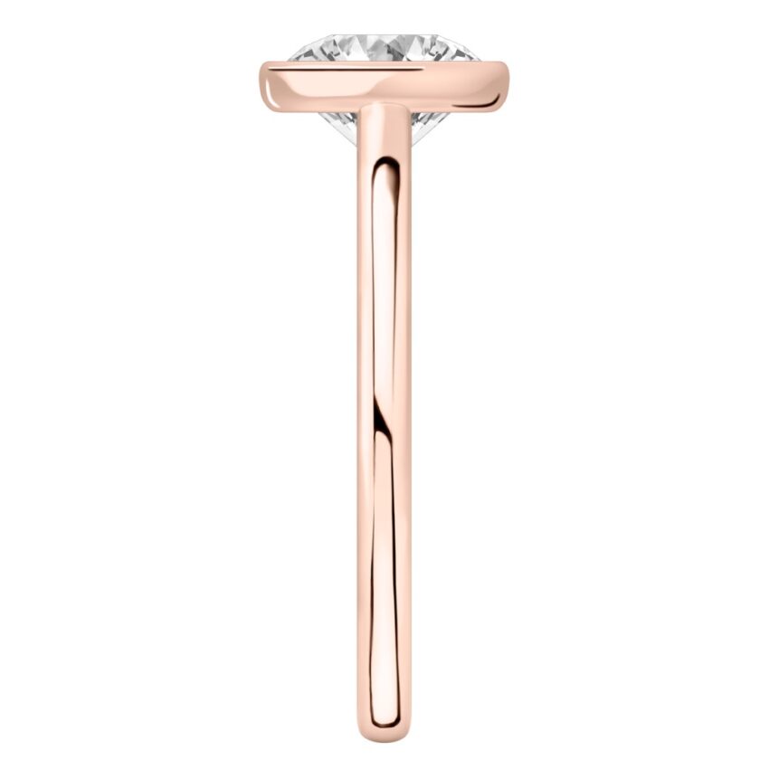 Side view of round cut diamond bezel engagement ring in rose gold