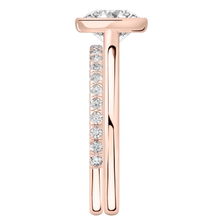 Side view of round cut diamond bezel engagement ring set rose gold