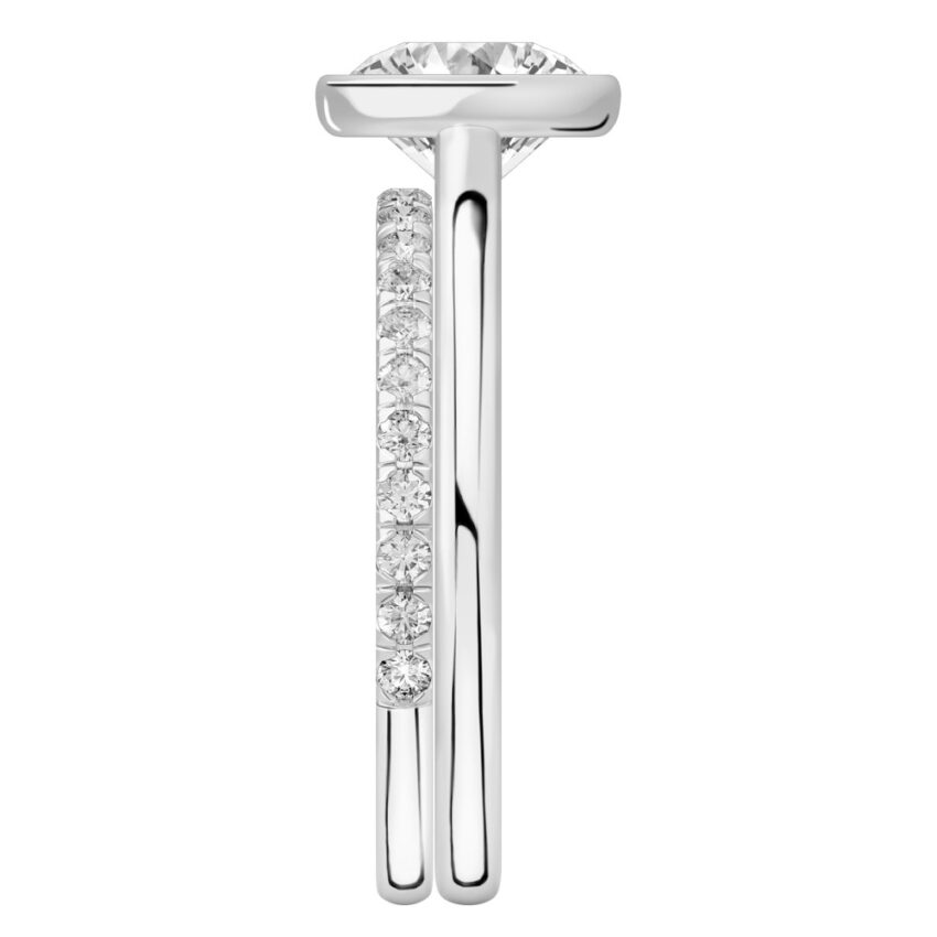Side view of round cut diamond bezel engagement ring set white gold