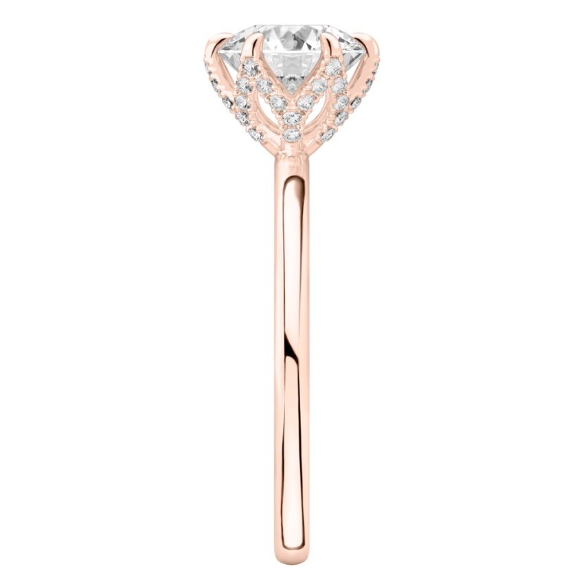 Side view of round cut diamond pave petal prong engagement ring in rose gold