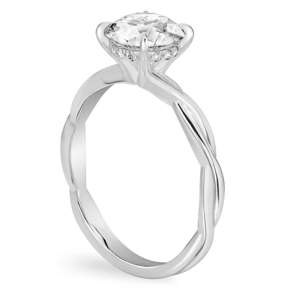 Angle view of round cut diamond twisted hidden halo engagement ring in platinum