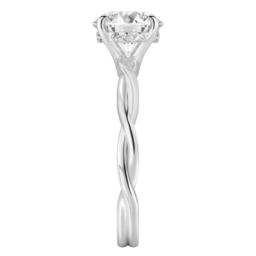 Side view of round cut diamond twisted hidden halo engagement ring in platinum