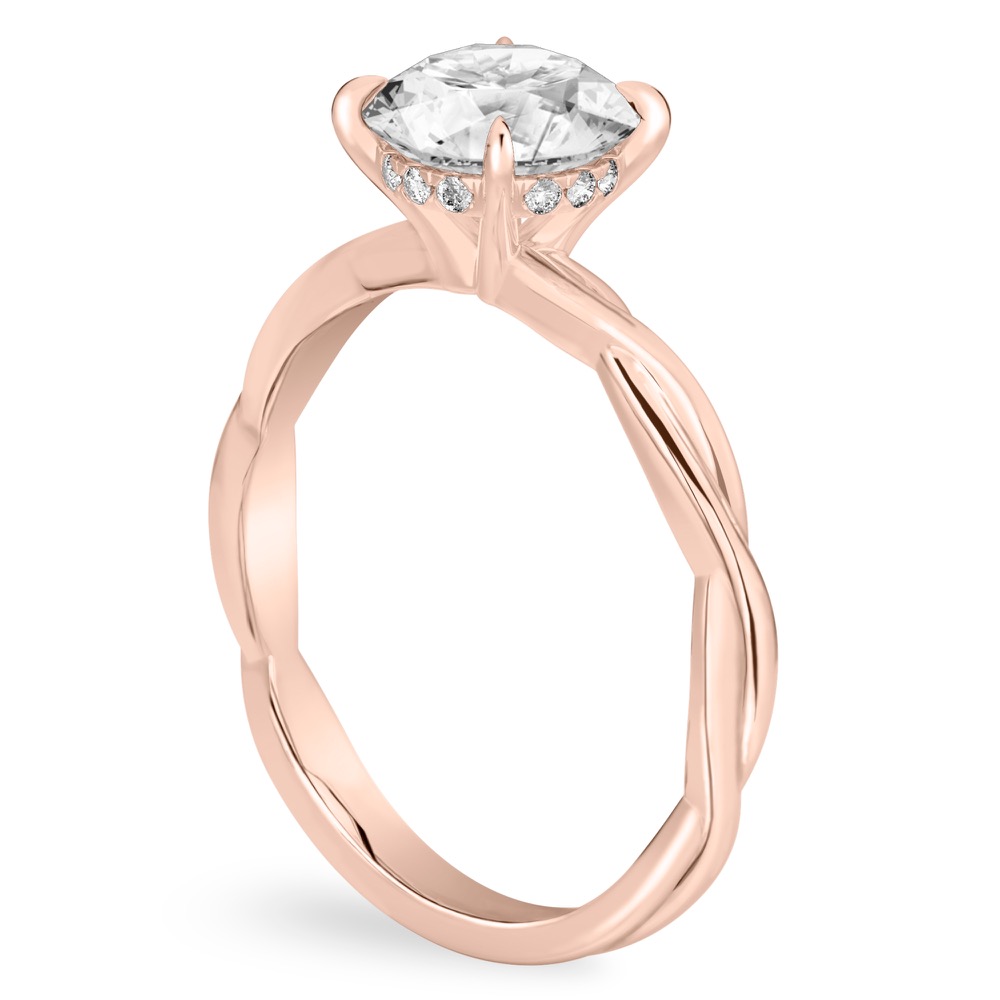 Angle view of round cut diamond twisted hidden halo engagement ring in rose gold