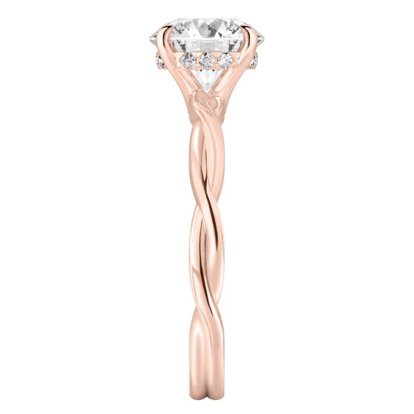 Side view of round cut diamond twisted hidden halo engagement ring in rose gold