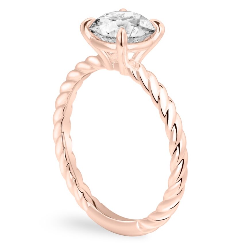 Angle view of round cut diamond twisted rope engagement ring in rose gold