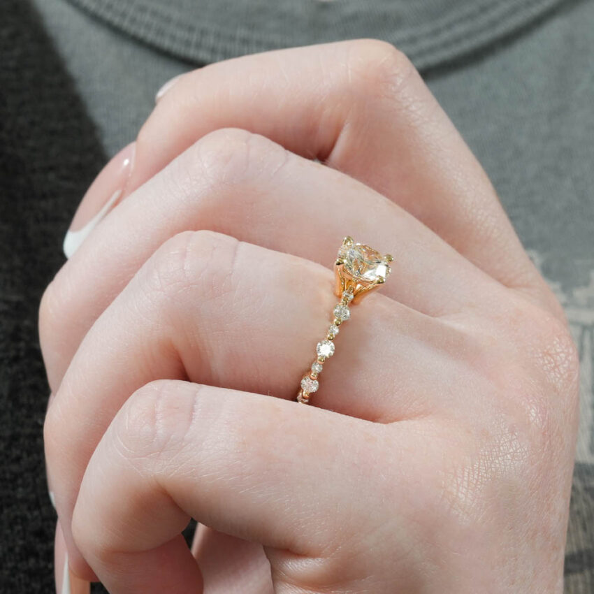 Angle view of single shared prong engagement ring in lifestyle