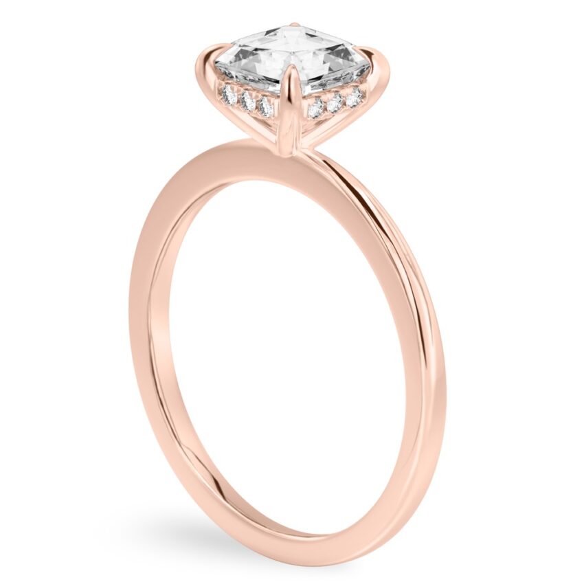 Angle view of asscher cut diamond hidden halo engagement ring in rose gold