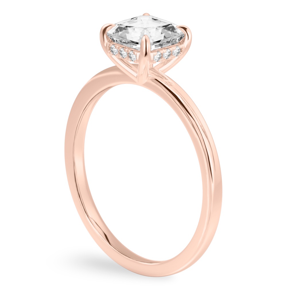 Angle view of asscher cut diamond ultra low hidden halo engagement ring in rose gold