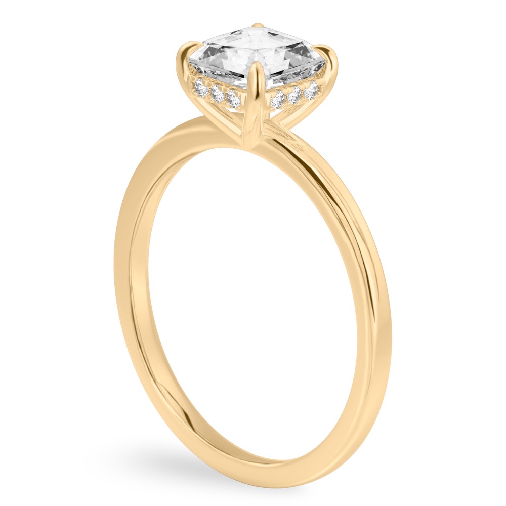 Angle view of asscher cut diamond ultra low hidden halo engagement ring in yellow gold