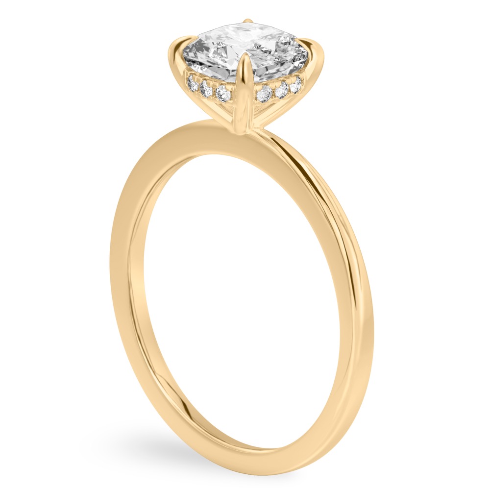Angle view of cushion cut diamond flush hidden halo engagement ring in yellow gold