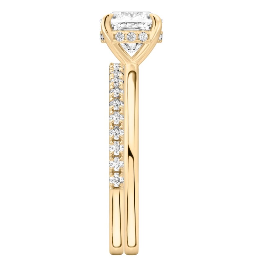 Side view of cushion cut diamond hidden halo engagement ring set yellow gold