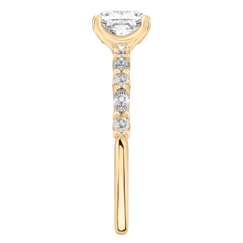Side view of cushion cut diamond marquise and round diamond ring yellow gold